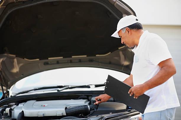 A professional car inspector is inspecting a car. Get your car inspected by a professional like German Precision or Prepurchase Check. Contact us today!